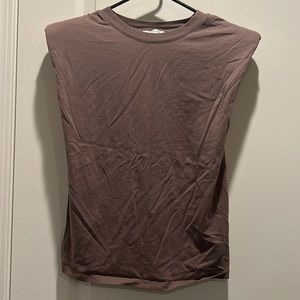 T-shirt with shoulder pads. Never worn